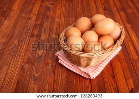 Fresh chicken eggs in the basket put on vintage tablecloth