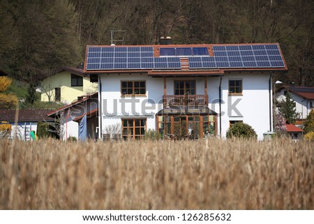Ecological family house with many solar panels on the roof
