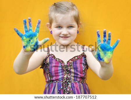Happy child with painted hands.  Painted hands.