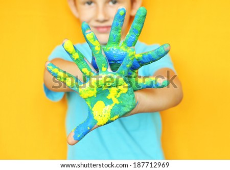 Happy child with painted hands. Hands painted .