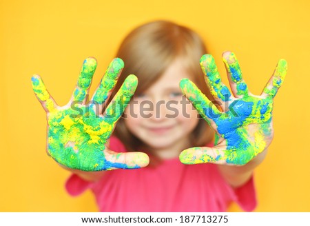 Happy child with painted hands. Hands painted .