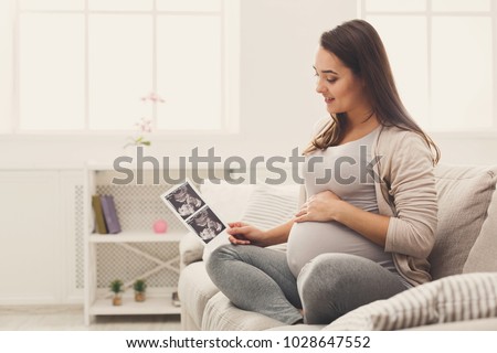 Similar – Image, Stock Photo Woman holding the ultrasound of her baby