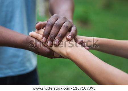 Black caregiver supporting woman, holding her hand outdoors. Philanthropy, kindness, volunteering concept, copy space 商業照片 © 