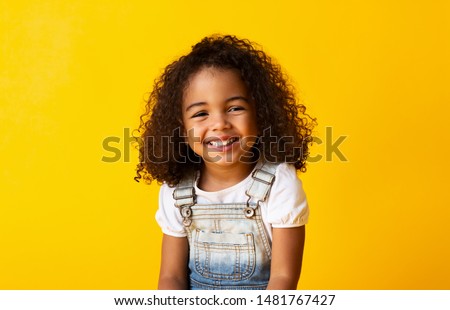 Similar – Image, Stock Photo A happy little girl in a white dress stands on a field with yellow flowers and smiles on a warm day