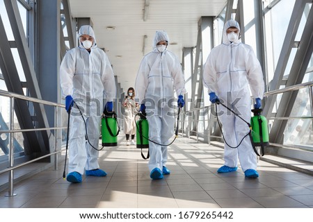 Specialist in hazmat suits cleaning disinfecting coronavirus cells epidemic, pandemic health risk