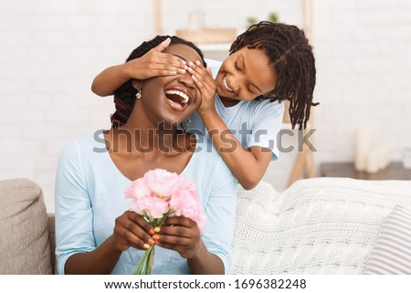 Similar – Image, Stock Photo girl in her mothers arms protected by a scarf