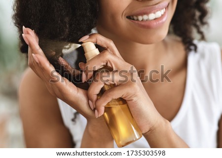 Similar – Image, Stock Photo Protected woman with curly hair is sitting in a sunny day while looking at camera and wearing a special mask