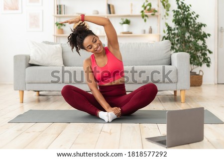 Black Fitness Woman Exercising At Laptop Having Online Training At Home. Stay Fit Concept