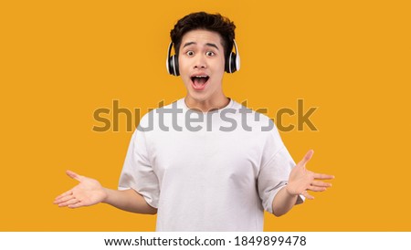 Similar – Image, Stock Photo Young Man with Earphones Posing in Autumn Park