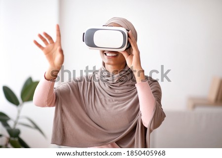 Similar – Image, Stock Photo Arab woman in VR headset on embankment