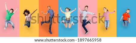 Happy Diverse Kids Jumping Posing Over Different Colorful Backgrounds. Collage With Joyful Multiracial Boys And Girls Jump Together. Carefree Childhood Concept. Panorama