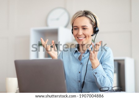 Millennial teacher giving online lesson on webcam from home, blogger broadcasting on air. Young tutor in headphones participating in educational or business web conference on laptop