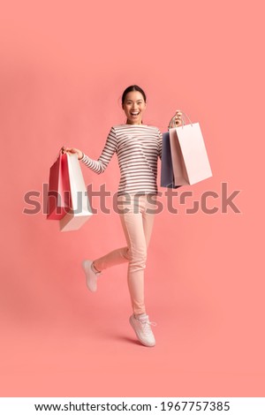 Big Sales Concept. Full Length Shot Of Young Happy Asian Woman Running With Colorful Shopping Bags Over Pink Background, Excited Korean Shopaholic Lady Enjoying Seasonal Discounts, Copy Space Сток-фото © 