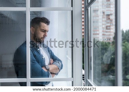 Similar – Image, Stock Photo Depressed man looking through window