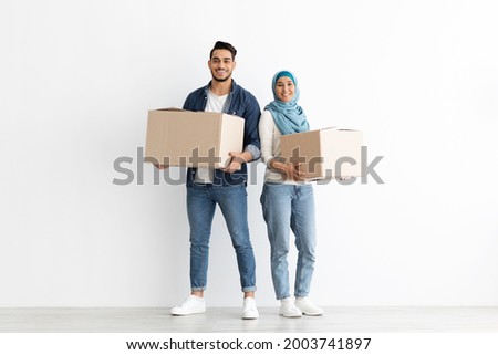 Similar – Image, Stock Photo Cheerful Arab woman with headphones on embankment