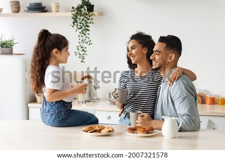 Similar – Image, Stock Photo Family sitting in coffee shop at store front in the city center, wearing the face mask to avoid virus infection
