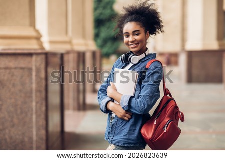 Similar – Image, Stock Photo Teenager girl with backpack and bike standing on metro station holding smart phone in hand, scrolling and texting, smiling and laughing. Futuristic bright subway station. Finland, Espoo