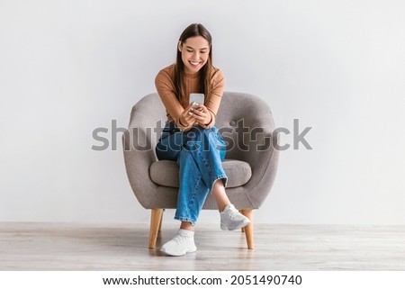 Similar – Image, Stock Photo Freelancer chatting on smartphone at table with laptop at home