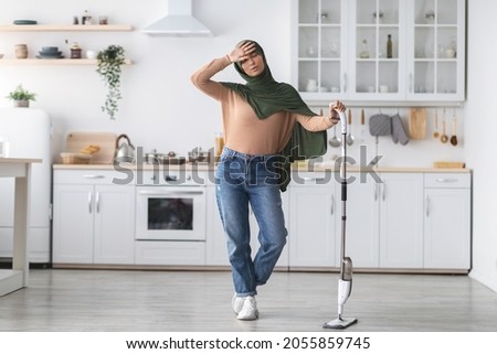 Similar – Image, Stock Photo Tired Arab woman wiping face with towel after training