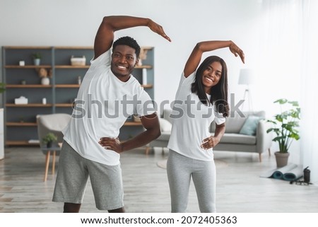 Similar – Image, Stock Photo Focused couple doing yoga in Awkward pose in park