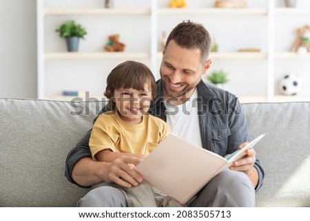 Similar – Image, Stock Photo Father and son reading book together