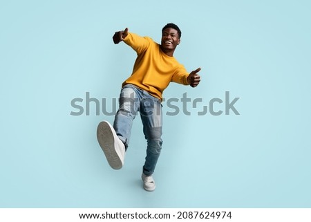 Similar – Image, Stock Photo Cheerful black man in stylish outfit on street