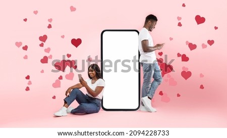 Photo of Modern Virtual Communication. Creative collage of young black couple texting, sending love sms, excited male and female leaning on big cell phone screen with blank white screen for mock up template