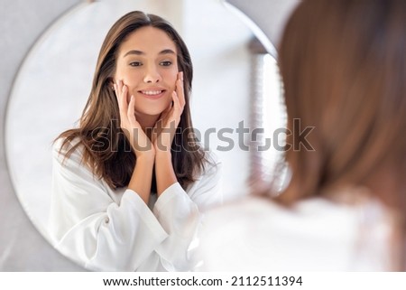Similar – Image, Stock Photo Beautiful woman touching face gently and covering body with blanket