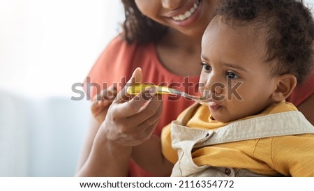 Similar – Image, Stock Photo Mom feeds her little son sitting on a chair in the kitchen