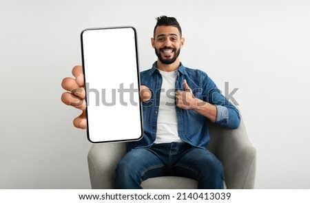 Similar – Image, Stock Photo Stylish man sitting at airport with suitcase and laptop, working, typing, browsing. Businessman traveling.