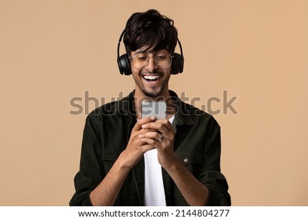 Similar – Image, Stock Photo beige wireless headphones on a purple background