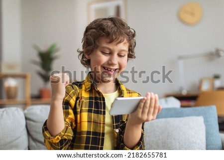 Similar – Image, Stock Photo Little gamer celebrating victory in VR game