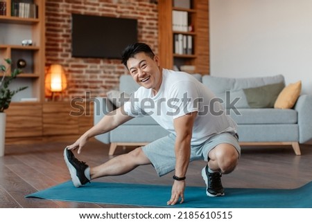 Similar – Image, Stock Photo Male making yoga exercise near window