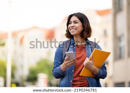 Similar – Image, Stock Photo Cheerful woman using smartphone in city