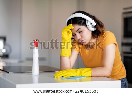Similar – Image, Stock Photo Tired Arab woman wiping face with towel after training