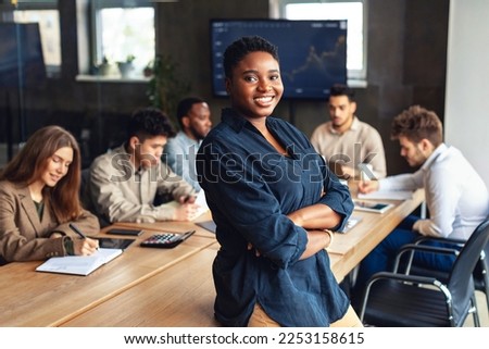 Image, Stock Photo Confident African American woman in stylish outfit at entrance of contemporary building with orange tiled facade