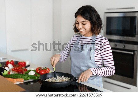 Similar – Image, Stock Photo Pan with rice and beans decorated with chopped green chilies and served on a wooden table