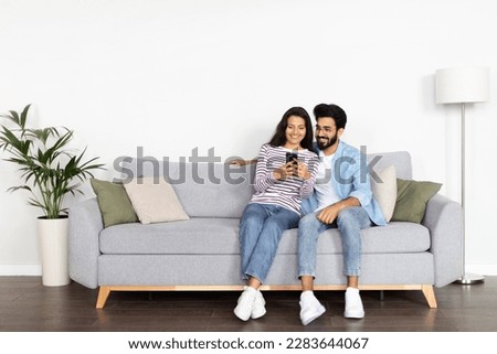 Similar – Image, Stock Photo Couple using smartphone together on bench