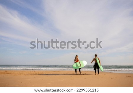 Similar – Image, Stock Photo Surfer friends at the beach with surfboards taking selfie with mobile phone