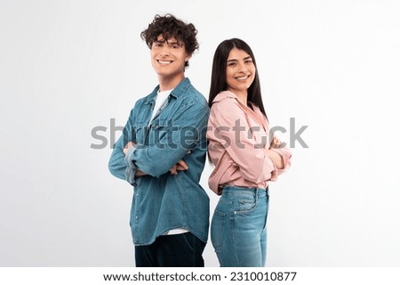 Similar – Image, Stock Photo Two young students standing outdoors holding laptop, backpack and study accessories while waiting for the bus to come and take them home. Studying outside home concept. Back to campus