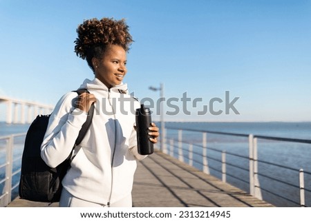 Image, Stock Photo Happy African American sportswoman with bottle of water