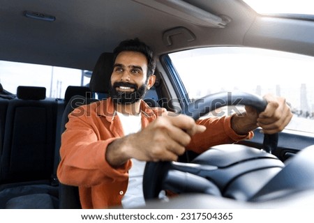 Similar – Image, Stock Photo Man sits in car and looks seriously out the window