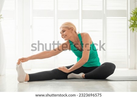 Similar – Image, Stock Photo Happy woman stretching legs during yoga class with trainer