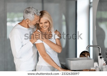 Similar – Image, Stock Photo Loving couple embracing while sitting on apartment floor