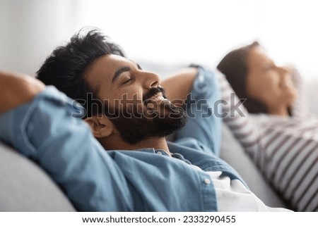 Similar – Image, Stock Photo Happy multiethnic lovers resting on sofa and kissing at home