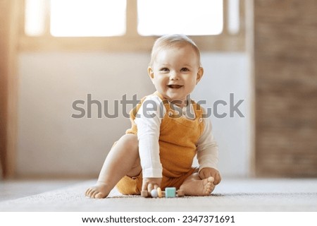 Similar – Image, Stock Photo Baby playing alone with toys on a carpet on the floor at home