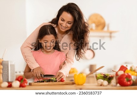 Similar – Image, Stock Photo A young mother teaches her little daughter to draw with colored pencils. Time together, creativity, education. Side view