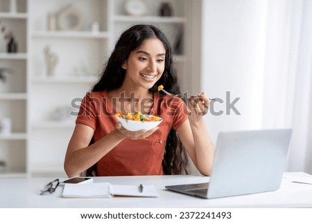 Similar – Image, Stock Photo Woman having lunch and browsing smartphone at home