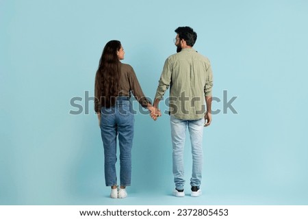 Similar – Image, Stock Photo Romantic multiethnic couple holding hands and strolling along city street