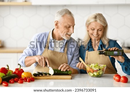 Similar – Image, Stock Photo Couple preparing food in kitchen.